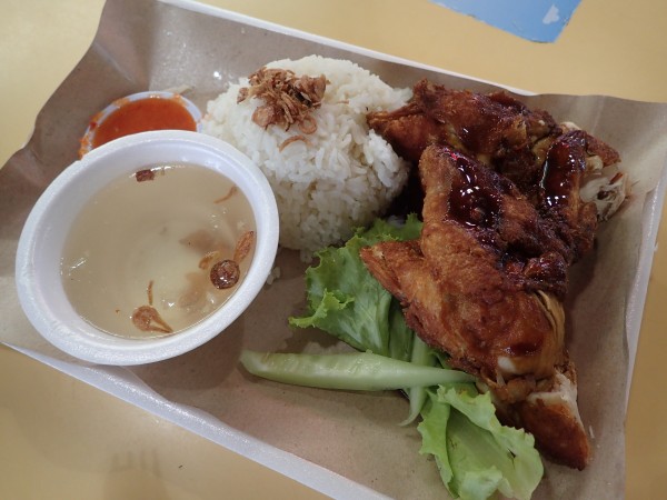 Nasi ayam is the Malay version of Hainanese chicken rice, with a deep-fried piece of chicken paired with flavorful rice and a dipping sauce.
